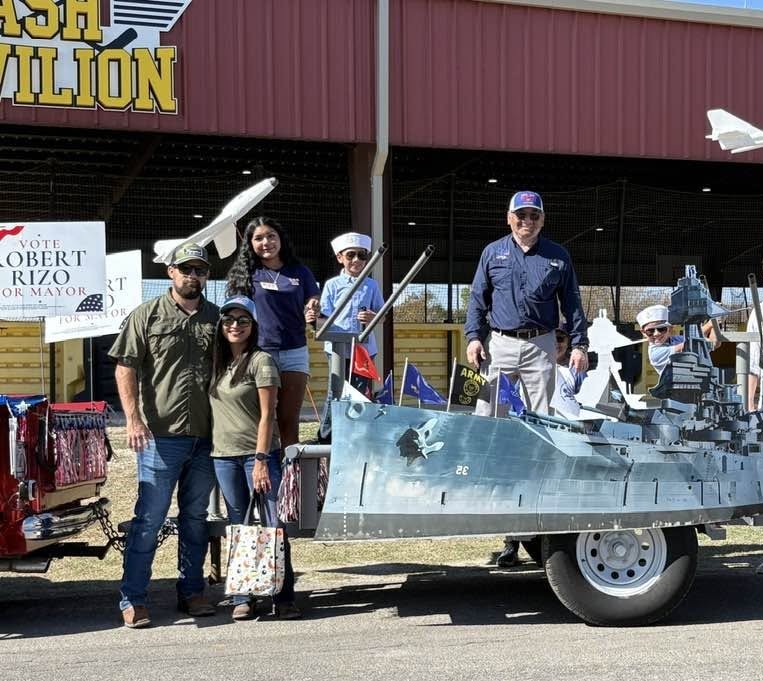 Robert Rizo with his family on his World War II ship-themed float at the Veterans Day Parade