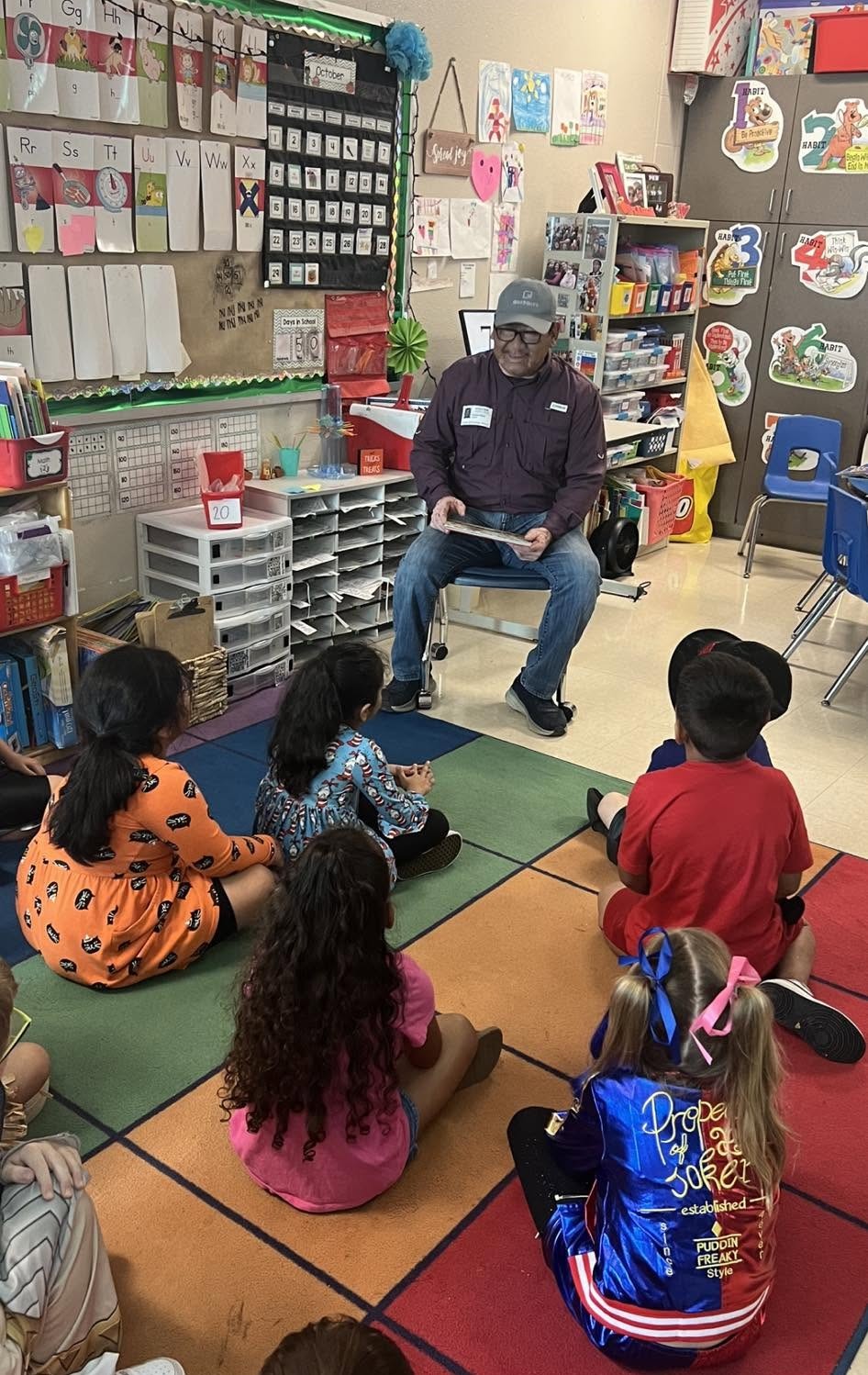 Robert Rizo reading to elementary school students